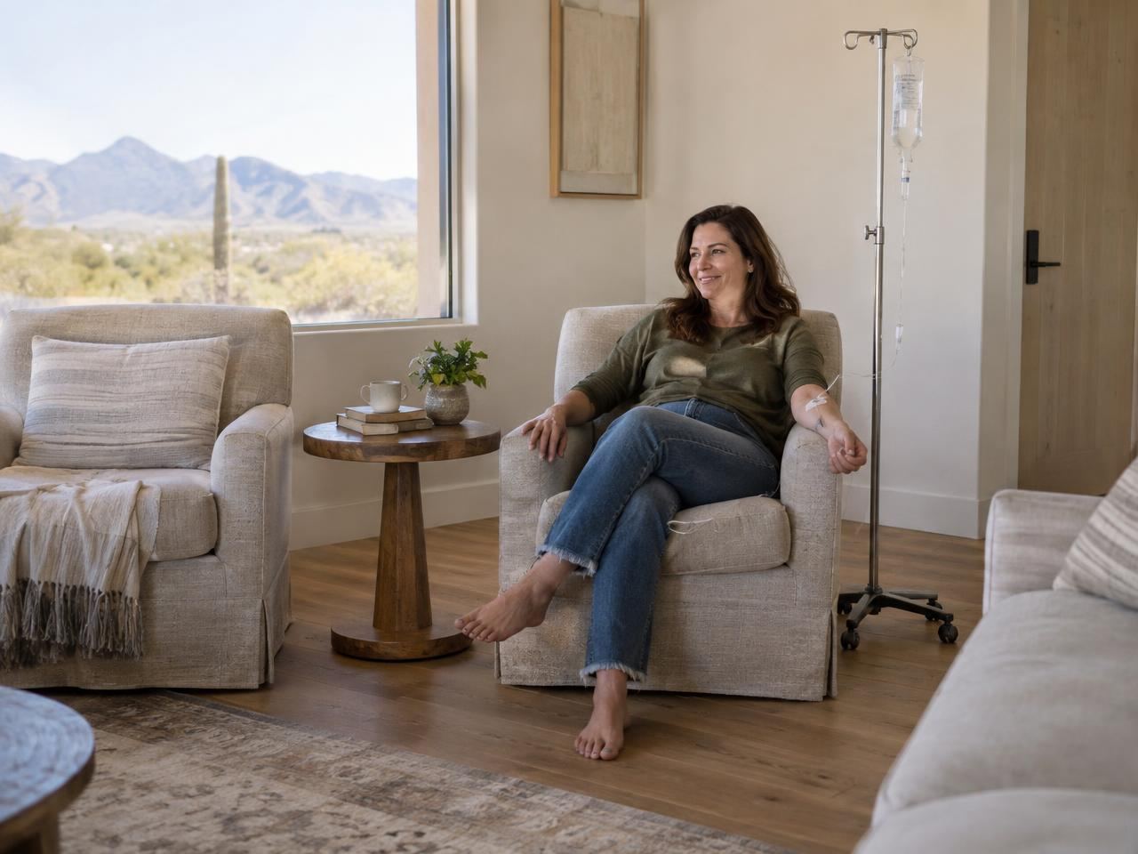 A woman relaxing in a comfy armchair at home during a mobile IV visit